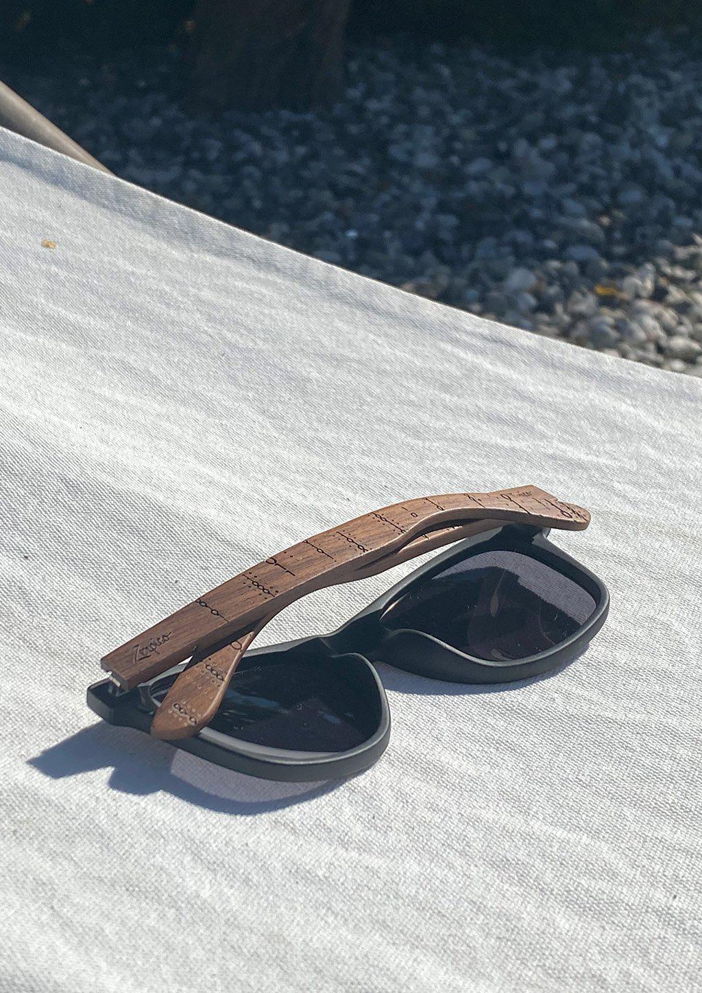 Zerpico BINARY Eyewood Engraved Wooden Sunglasses Folded on a Hammock Showcasing Hand-Carved Wooden Arms