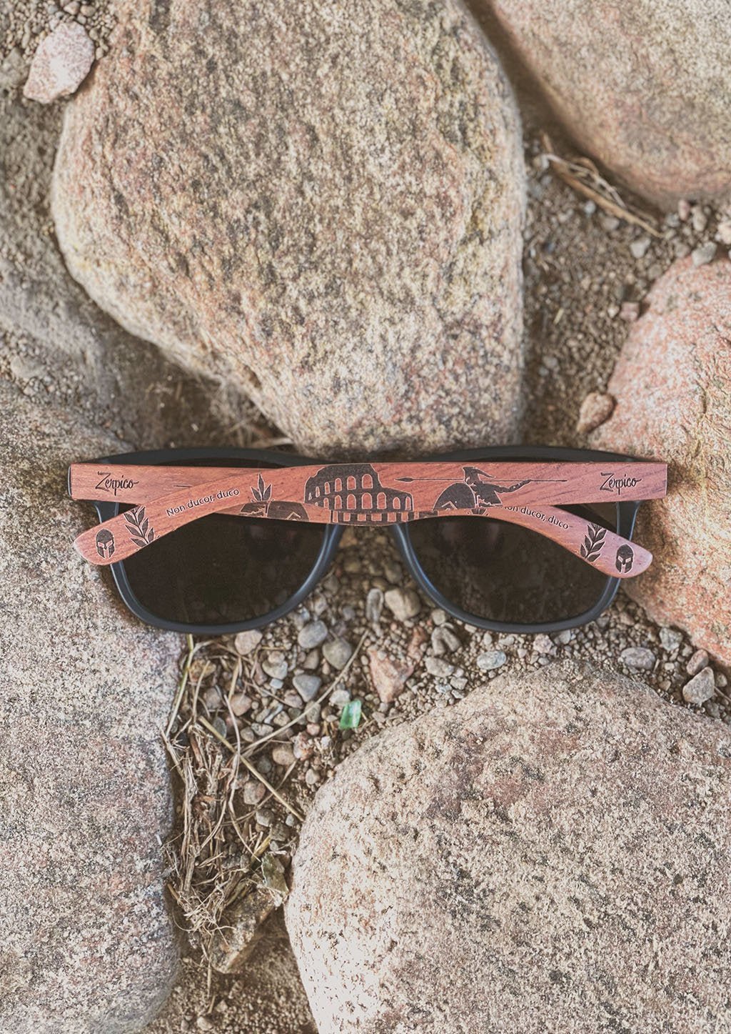 Zerpico GLADIATOR Eyewood Engraved Wooden Sunglasses - Folded On a Rock Path Highlighting Hand-Carved Wooden Arms